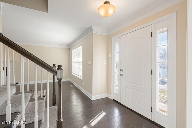 entryway with dark hardwood / wood-style floors and ornamental molding