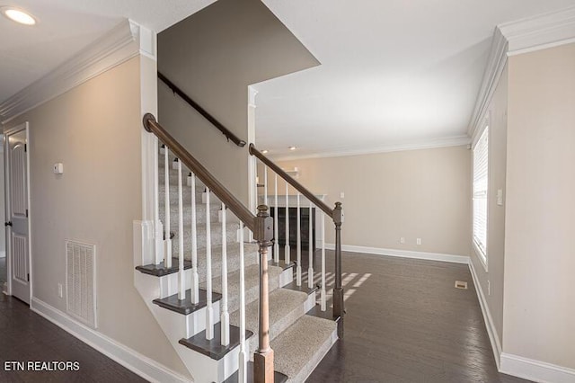 stairs featuring crown molding and hardwood / wood-style floors