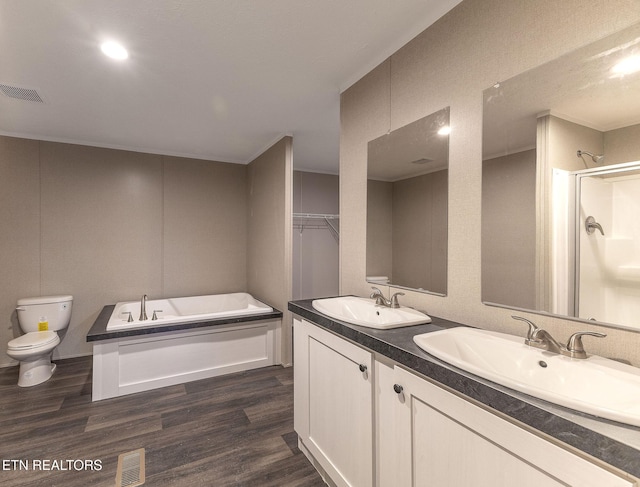 full bathroom featuring plus walk in shower, toilet, vanity, and hardwood / wood-style flooring