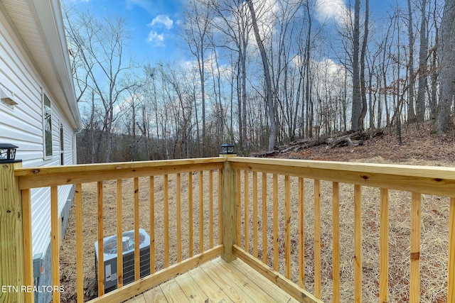 wooden deck featuring central AC unit