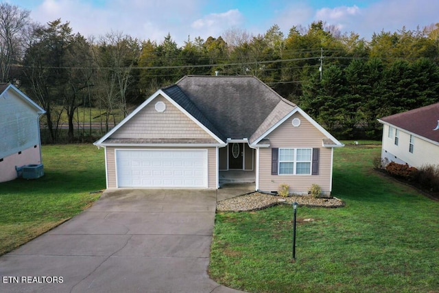 view of front of property with a garage and a front lawn