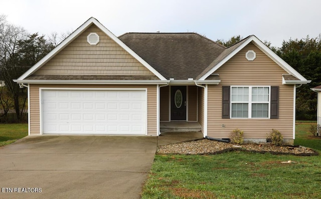 view of front of property featuring a front yard and a garage