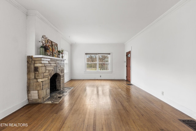 unfurnished living room featuring crown molding, a fireplace, and hardwood / wood-style flooring