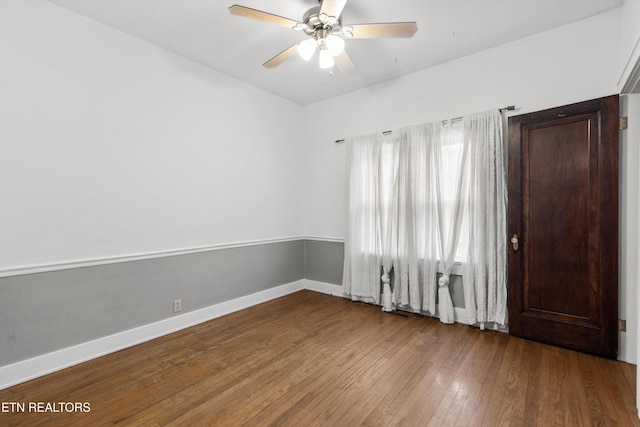 spare room with ceiling fan and wood-type flooring