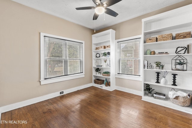 empty room with dark hardwood / wood-style floors and ceiling fan