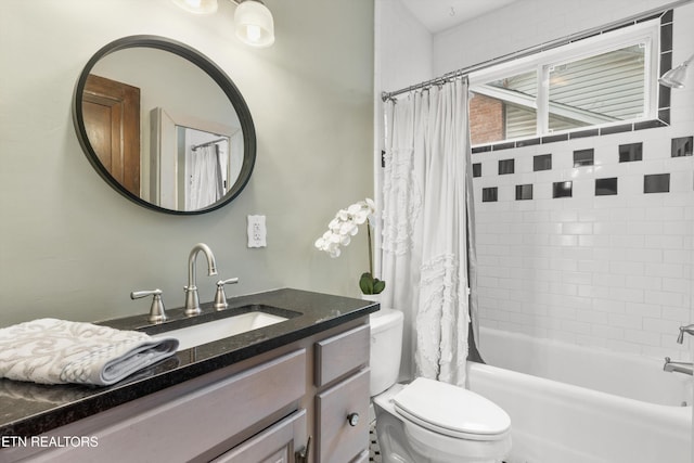 full bathroom featuring vanity, shower / tub combo, and toilet