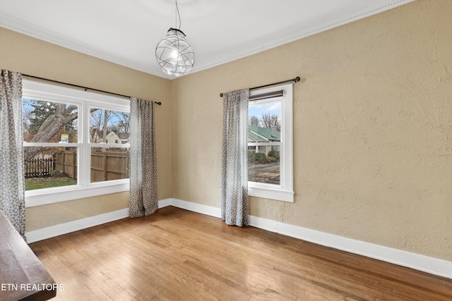 unfurnished room featuring hardwood / wood-style floors and ornamental molding