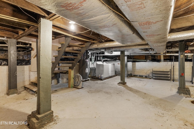 basement with separate washer and dryer and electric water heater