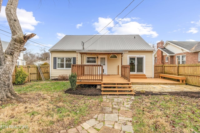 back of property featuring a lawn and a wooden deck