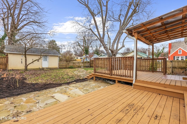 wooden terrace featuring an outbuilding