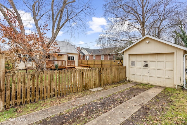 view of yard featuring a wooden deck, an outbuilding, and a garage