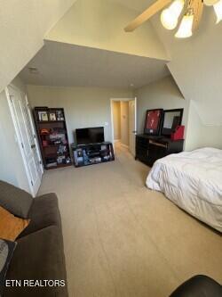 bedroom with ceiling fan, carpet flooring, and vaulted ceiling with beams