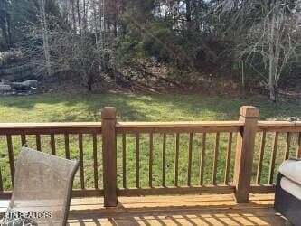 wooden deck featuring a yard