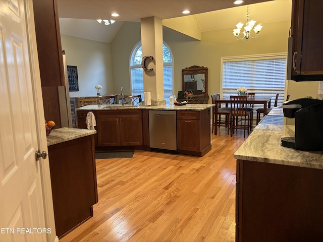 kitchen with lofted ceiling, pendant lighting, light hardwood / wood-style flooring, stainless steel dishwasher, and kitchen peninsula