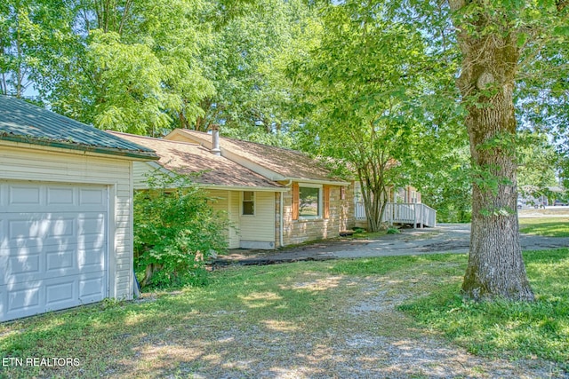 exterior space featuring a yard and a garage