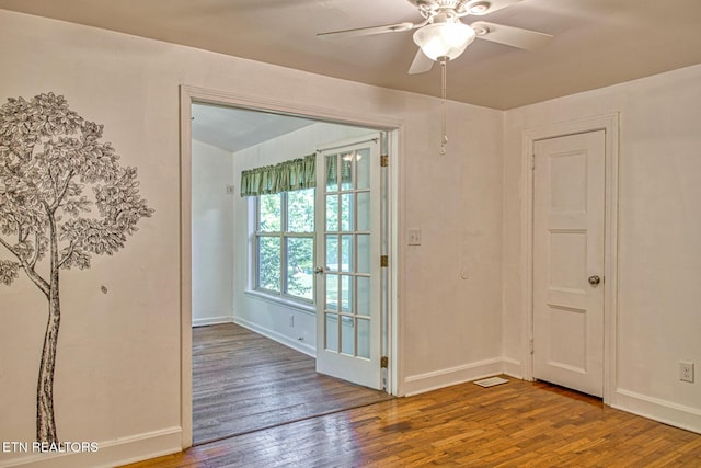 spare room with hardwood / wood-style floors, ceiling fan, and french doors