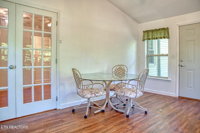 dining room featuring french doors, lofted ceiling, and hardwood / wood-style flooring