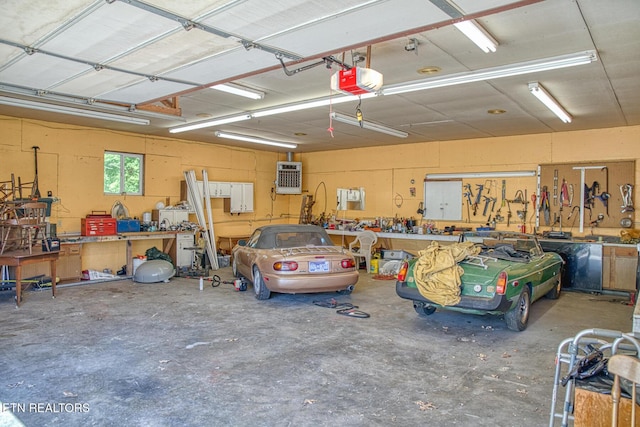 garage with a workshop area and a garage door opener