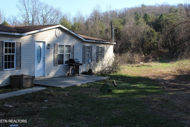 exterior space with a lawn and a patio