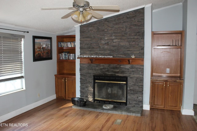 unfurnished living room with a stone fireplace, ceiling fan, wood-type flooring, and lofted ceiling