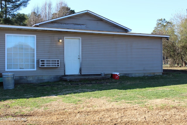 rear view of property featuring a yard