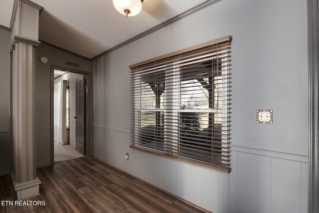 hallway featuring lofted ceiling, crown molding, dark hardwood / wood-style floors, and a textured ceiling