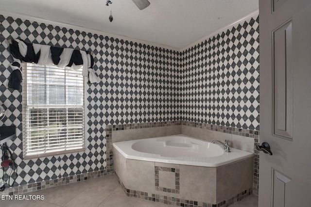 bathroom with tiled tub, crown molding, tile patterned flooring, and a textured ceiling