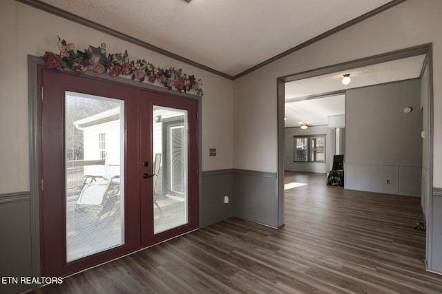 entryway with french doors, dark hardwood / wood-style flooring, crown molding, a textured ceiling, and lofted ceiling