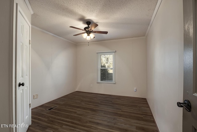 spare room with dark hardwood / wood-style floors, ceiling fan, ornamental molding, and a textured ceiling