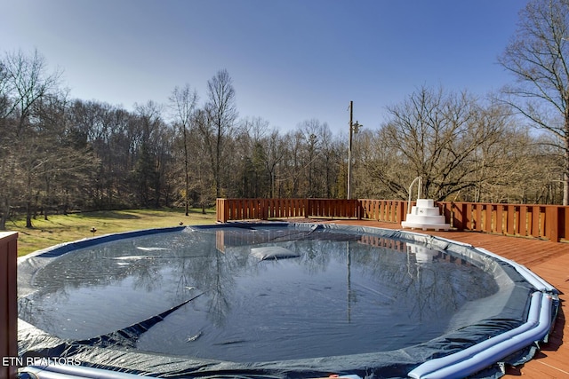 view of swimming pool with a deck