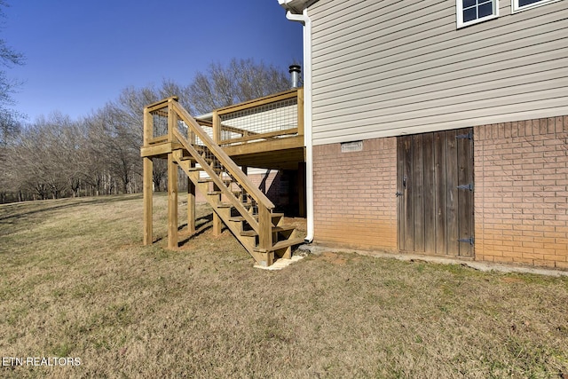 view of home's exterior with a wooden deck and a yard