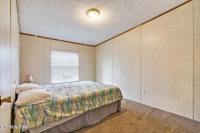 carpeted bedroom with a textured ceiling