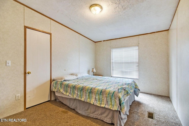 carpeted bedroom featuring a textured ceiling