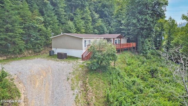 view of front facade with central AC unit and a wooden deck