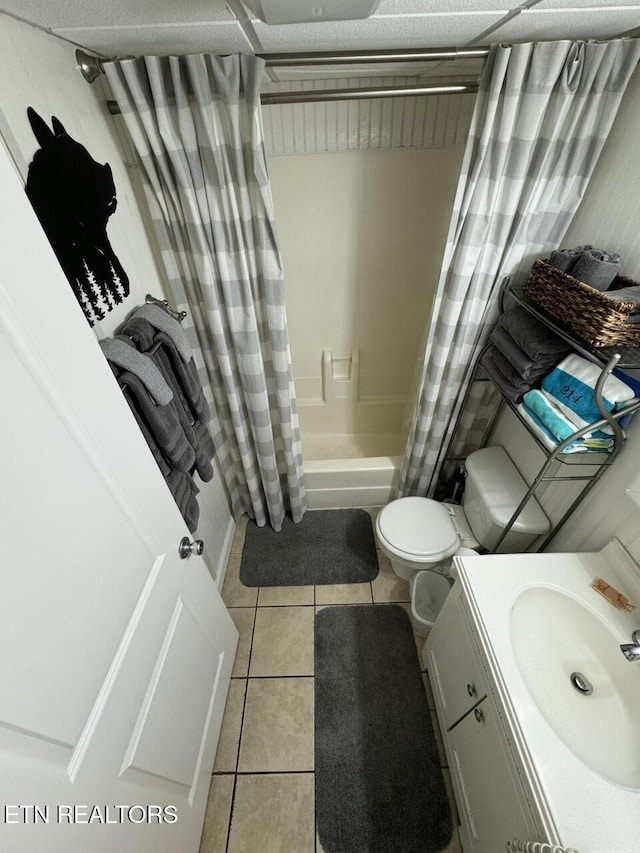 full bathroom with tile patterned flooring, vanity, toilet, and shower / bath combo with shower curtain