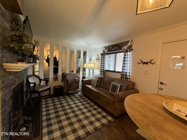 living room featuring a textured ceiling, dark hardwood / wood-style flooring, and crown molding