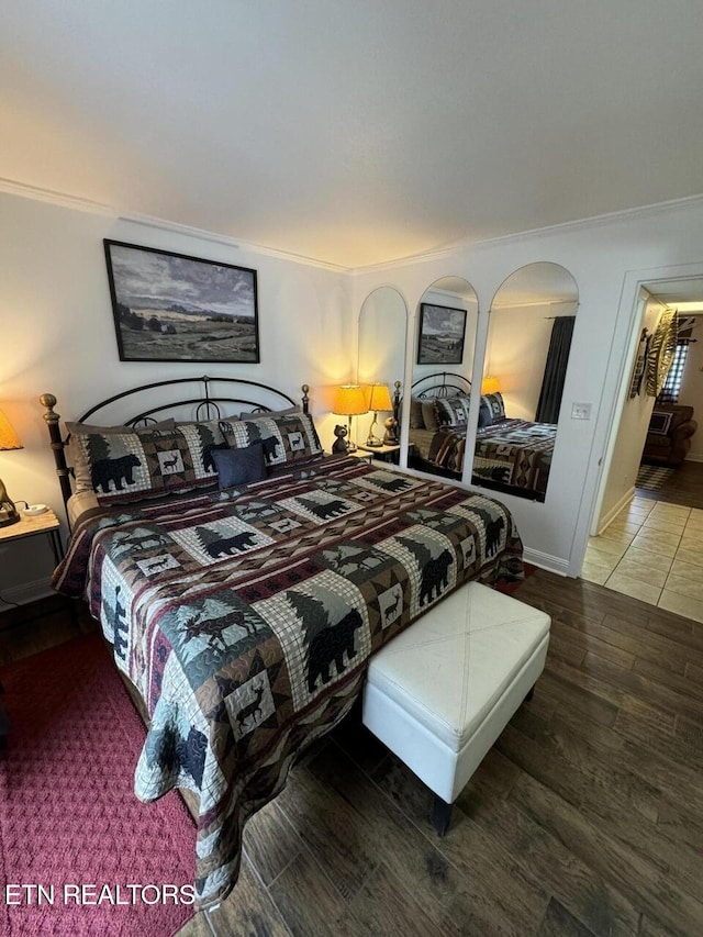 bedroom featuring hardwood / wood-style flooring and ornamental molding