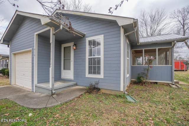 view of front of house featuring a sunroom and a garage