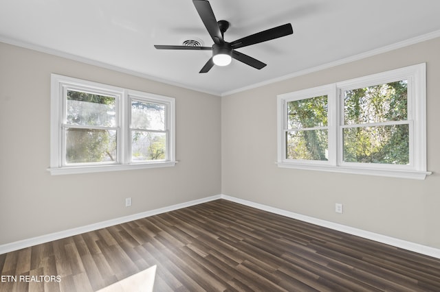 unfurnished room featuring crown molding, ceiling fan, dark wood-type flooring, and a healthy amount of sunlight