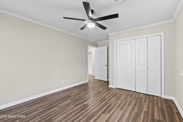 unfurnished bedroom with ceiling fan, dark hardwood / wood-style floors, ornamental molding, and a closet