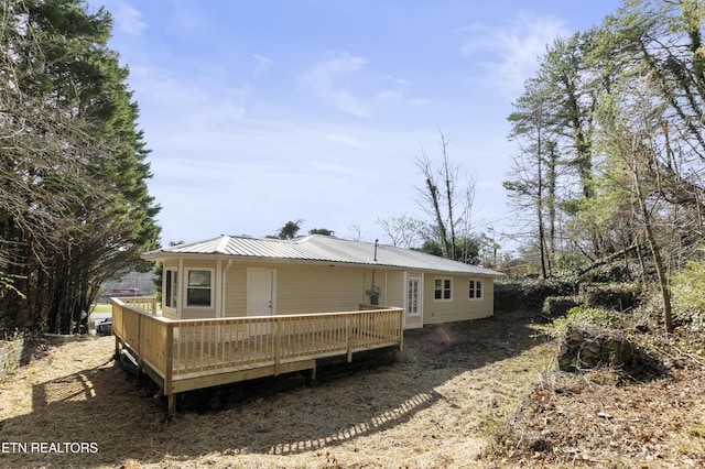 rear view of property featuring a deck