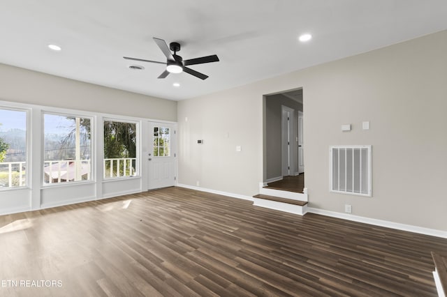 unfurnished living room featuring ceiling fan and dark hardwood / wood-style floors