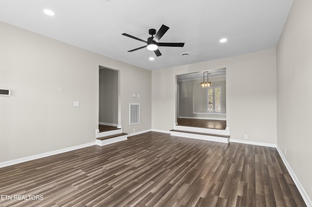 unfurnished living room featuring dark hardwood / wood-style flooring and ceiling fan