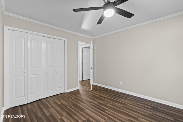 unfurnished bedroom featuring ceiling fan, dark hardwood / wood-style floors, crown molding, and a closet