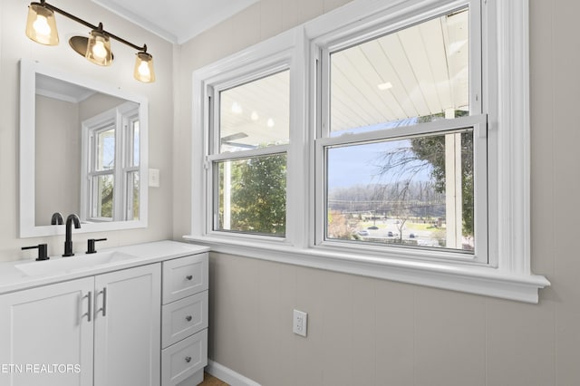 bathroom featuring crown molding and vanity