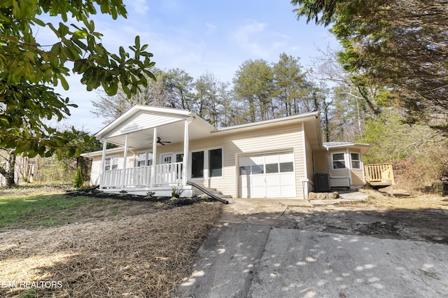 view of front of property featuring ceiling fan, a porch, and a garage