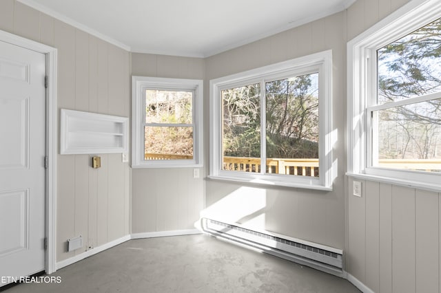 unfurnished sunroom featuring a baseboard heating unit