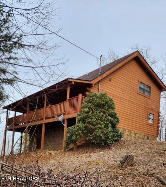 rear view of property featuring a deck