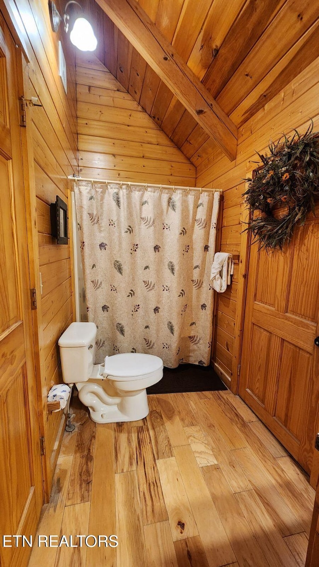 bathroom featuring hardwood / wood-style floors, wood walls, toilet, and wooden ceiling