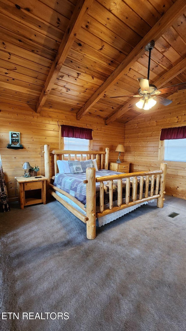 unfurnished bedroom featuring carpet flooring, ceiling fan, beam ceiling, wooden ceiling, and wood walls